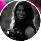 Woman holding camera smiling